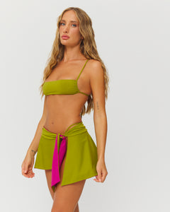 model wearing green bikini top and skirt 